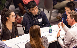 Students and alumna in discussion